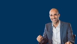 man in jacket holding glasses